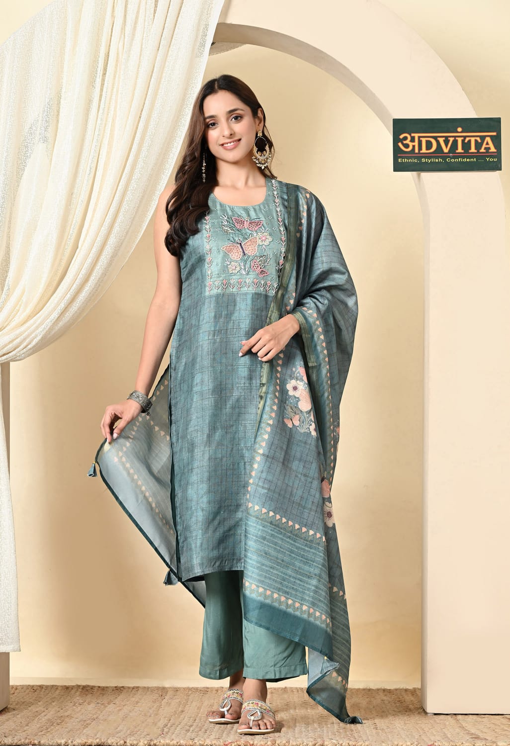 Woman wearing teal blue party wear 3-piece suit with kurti pant and dupatta