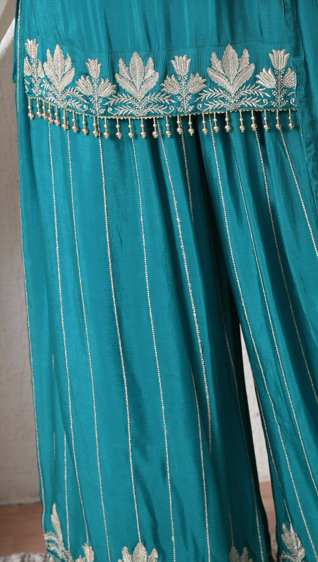 Detail view of embroidery work on teal green sharara outfit