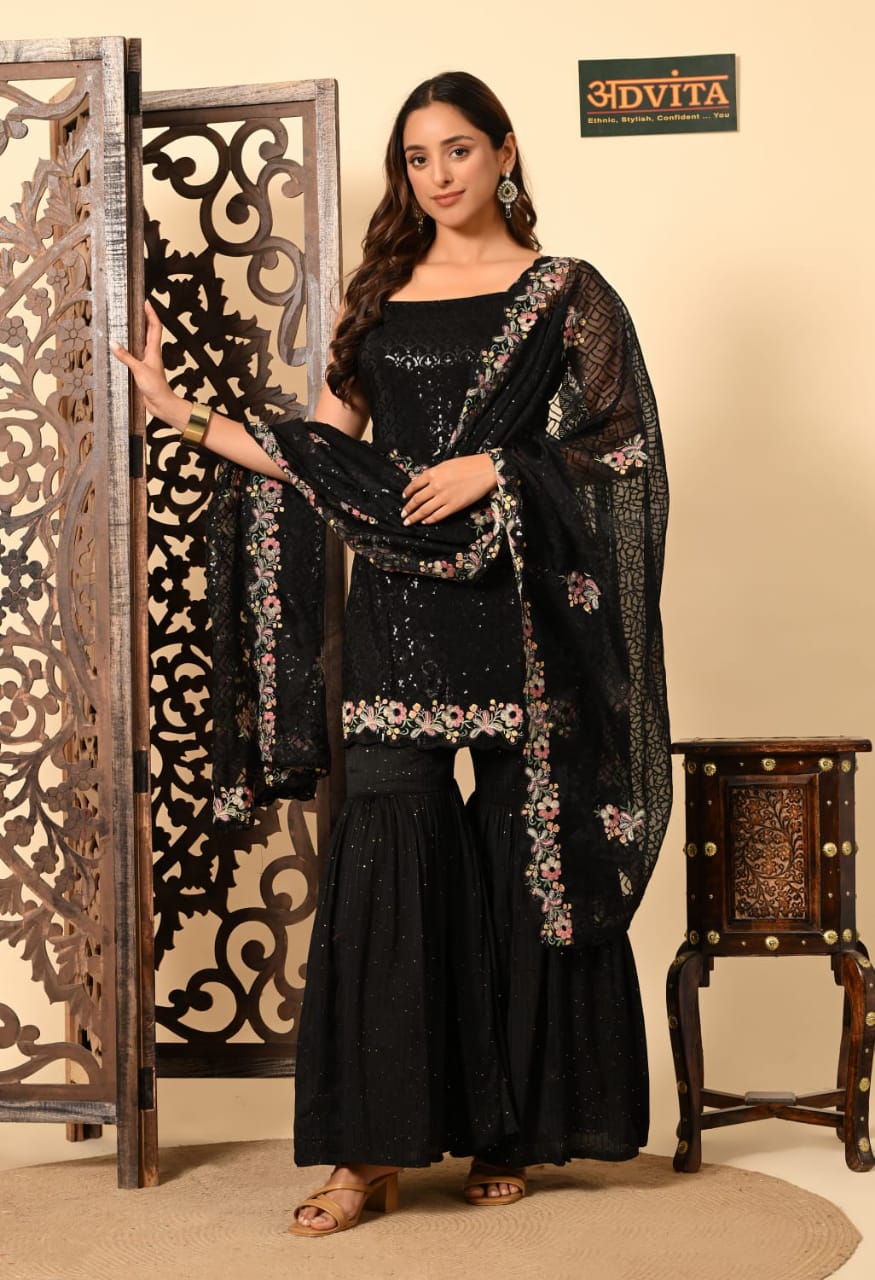 Woman wearing black sharara suit with dupatta