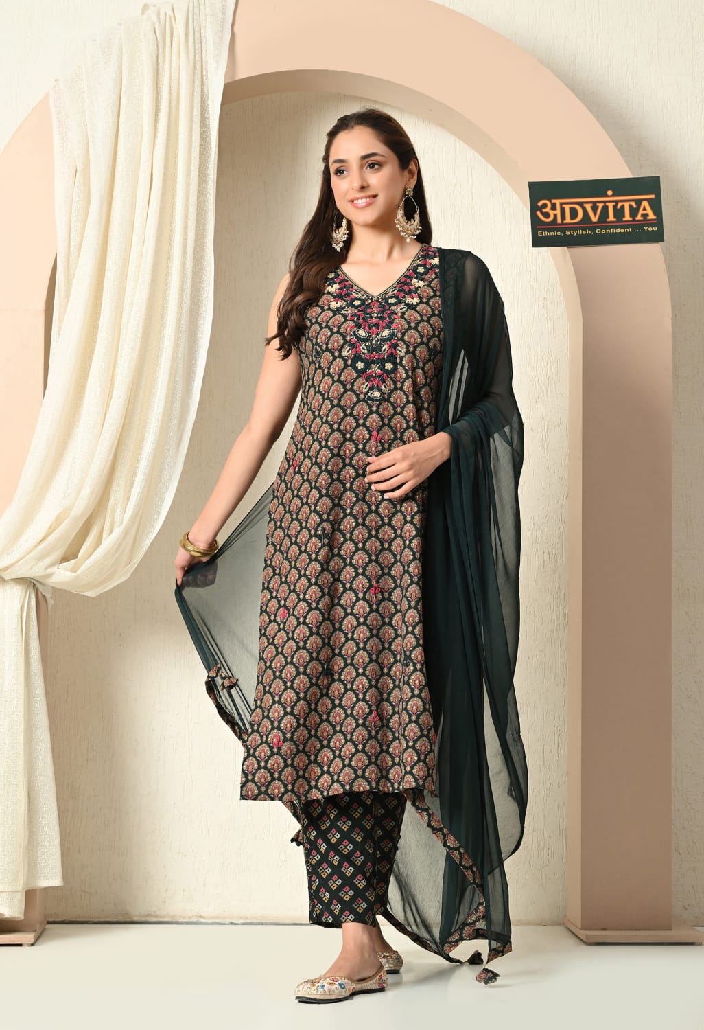 Woman wearing green cotton kurti pant dupatta set