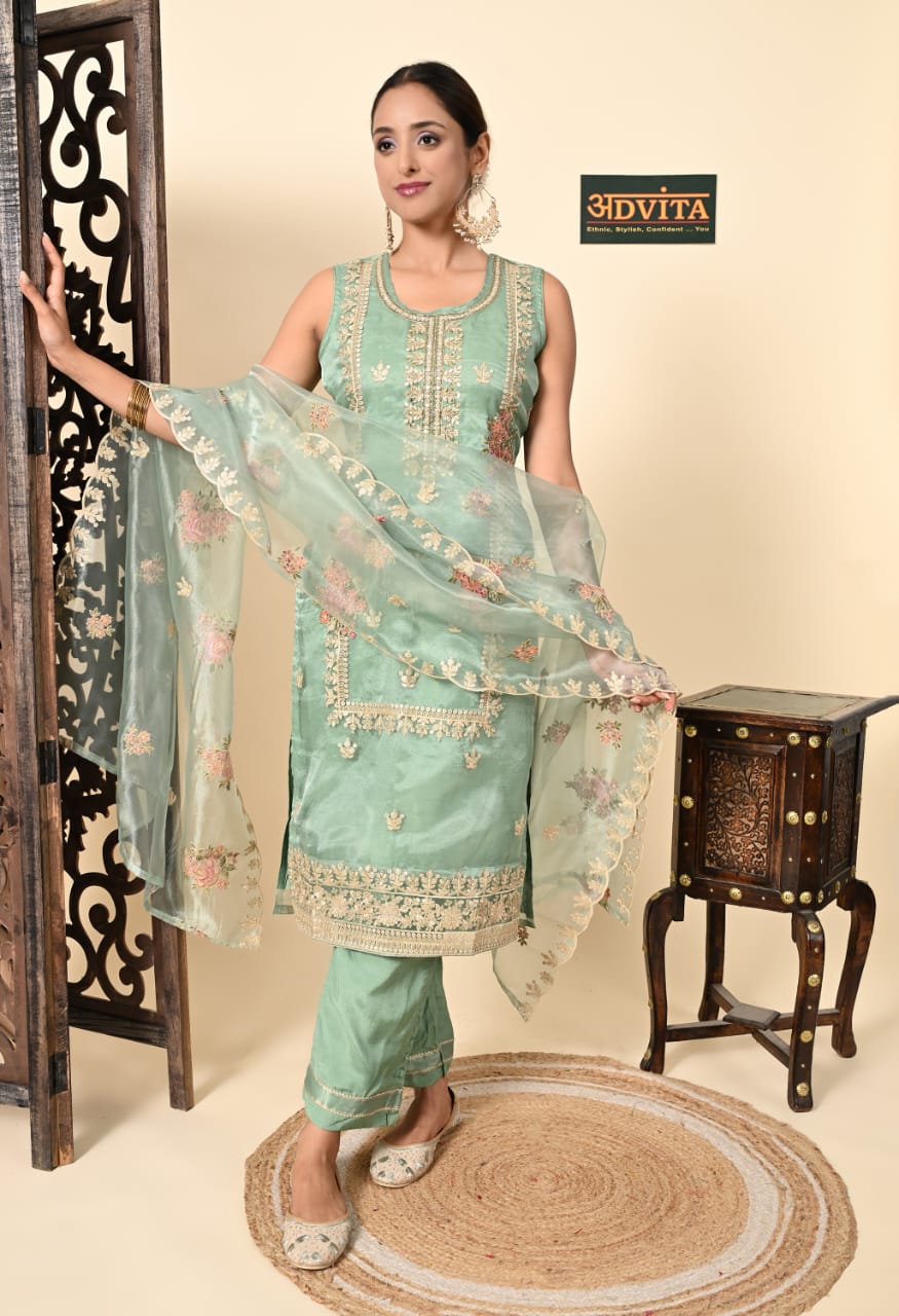 Woman wearing pista green kurti pant dupatta set for festive wear