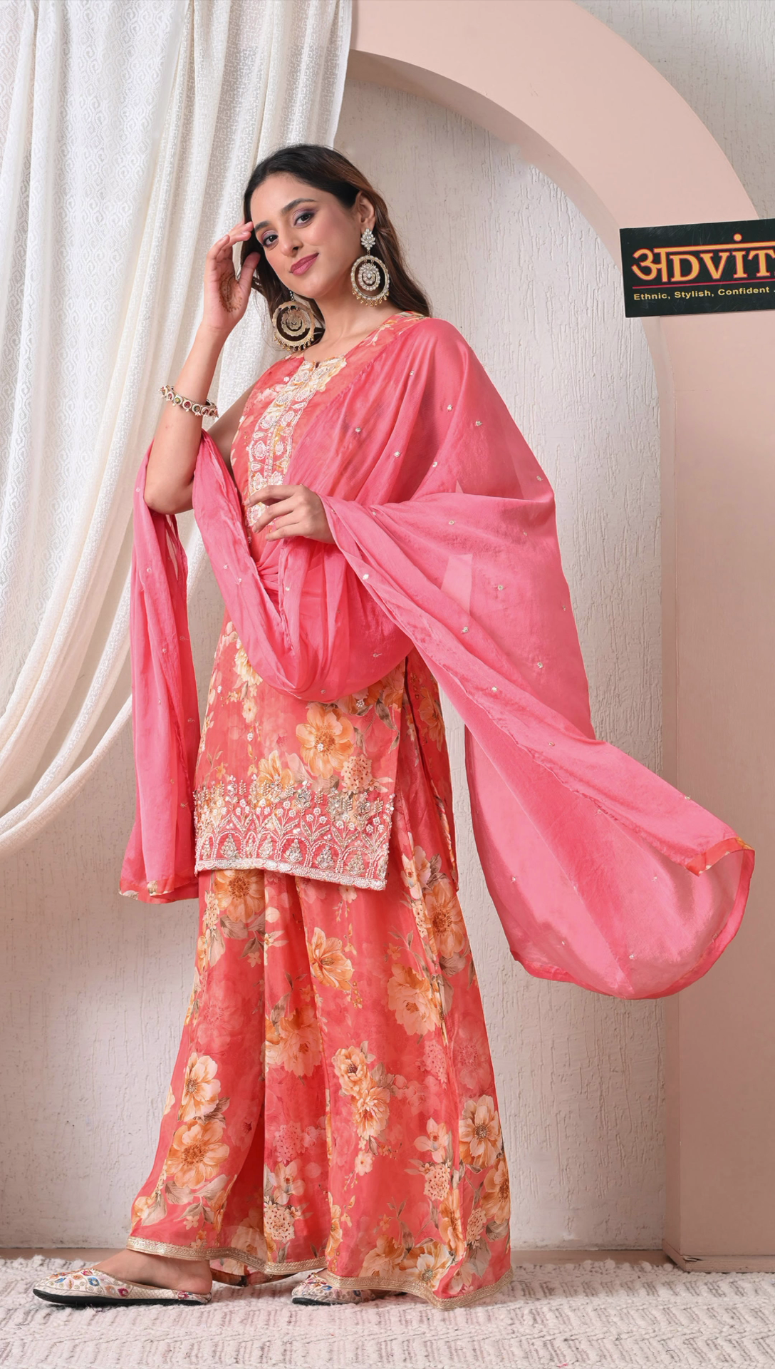 Side view of coral pink party wear sharara suit with dupatta