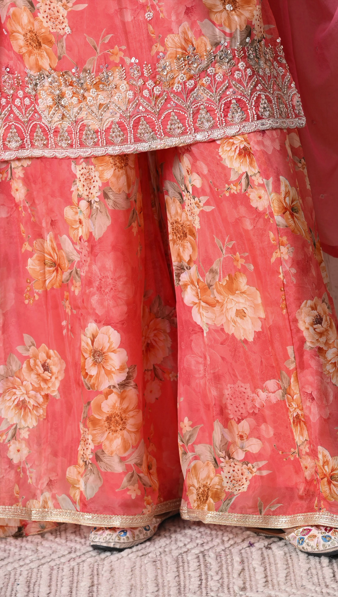 Side view of coral pink party wear sharara suit with dupatta