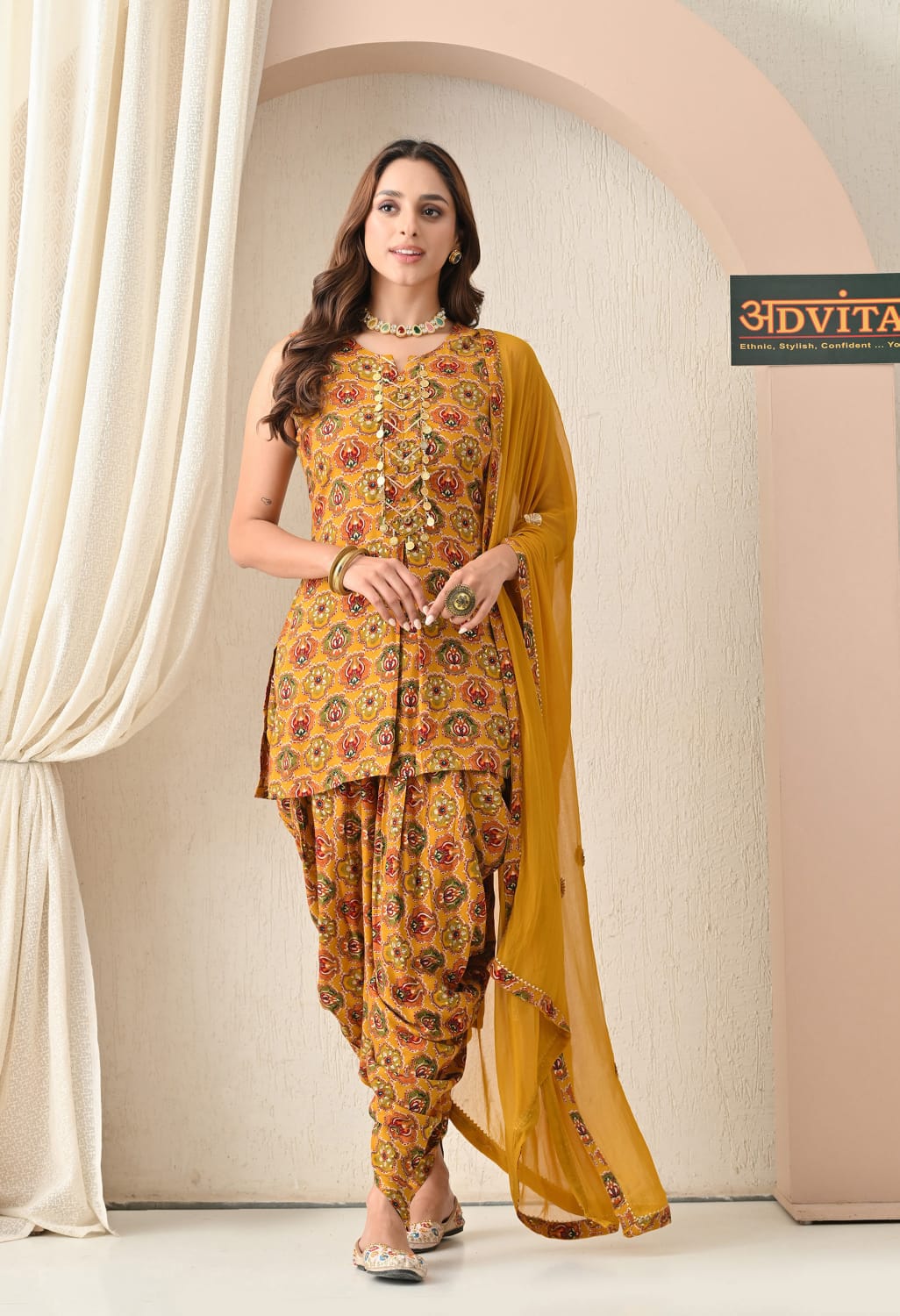 Woman wearing mustard yellow printed dhoti suit with dupatta