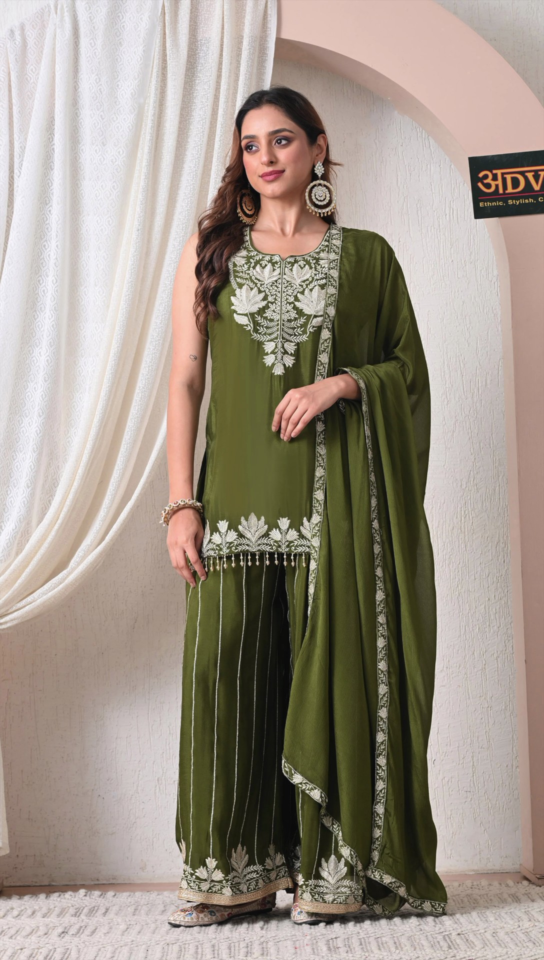 Woman wearing olive green chinon embroidered sharara set with dupatta
