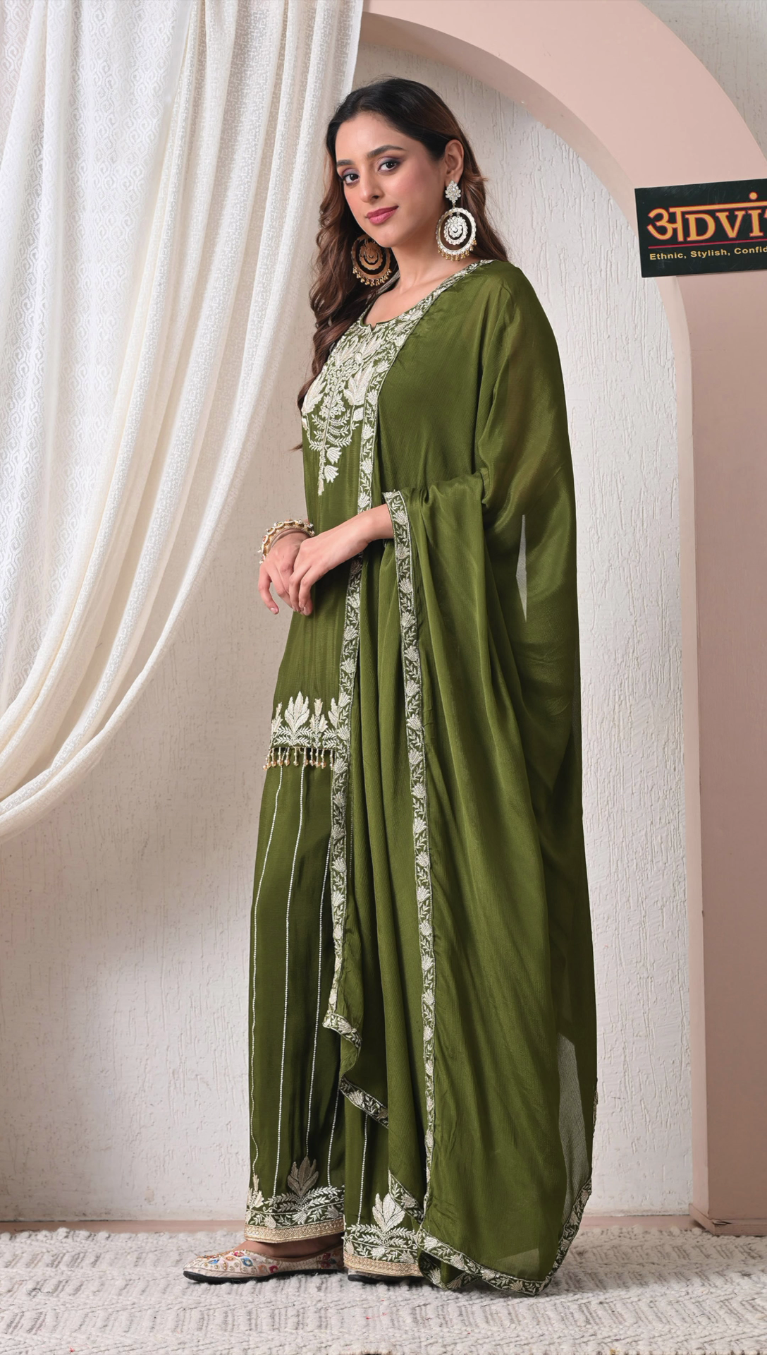 Side view of olive green festive sharara outfit for women