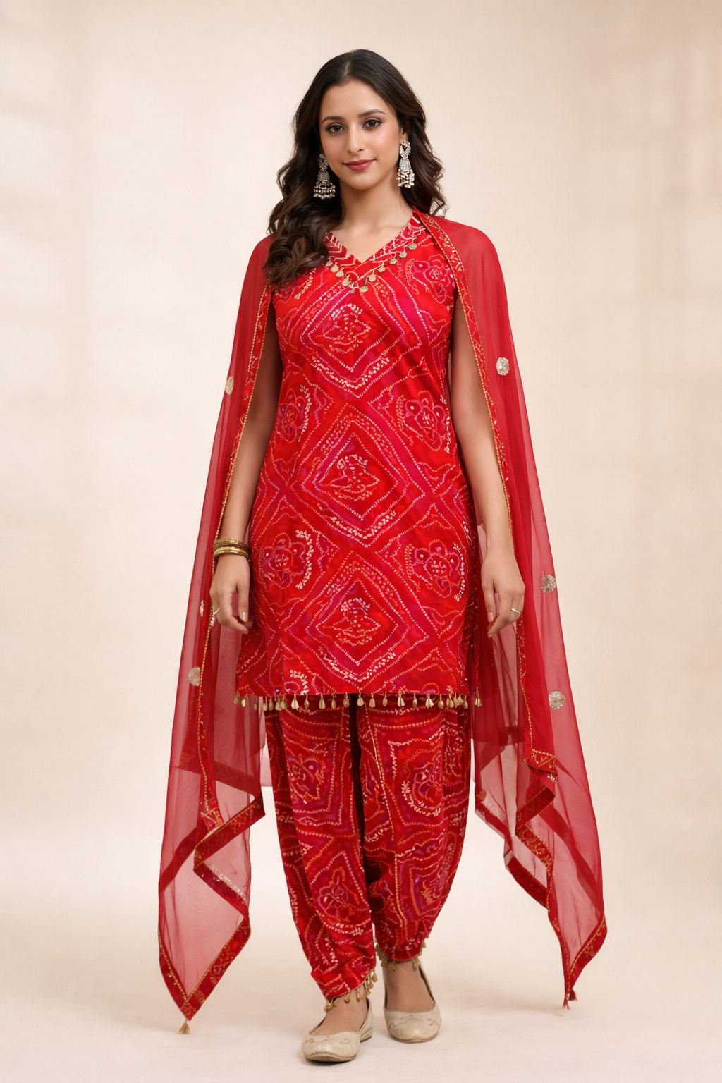 Woman wearing red bandhani print dhoti suit with dupatta