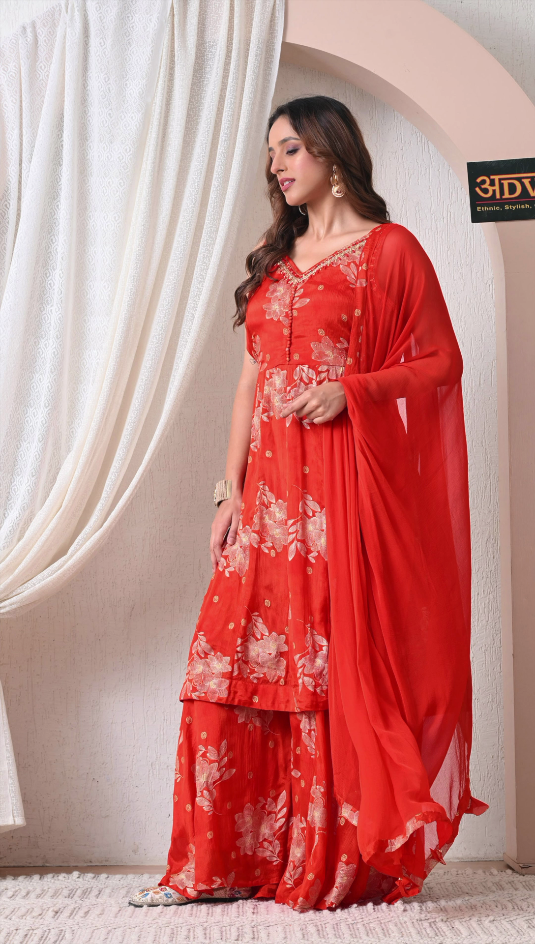 Side view of red floral printed sharara outfit for women