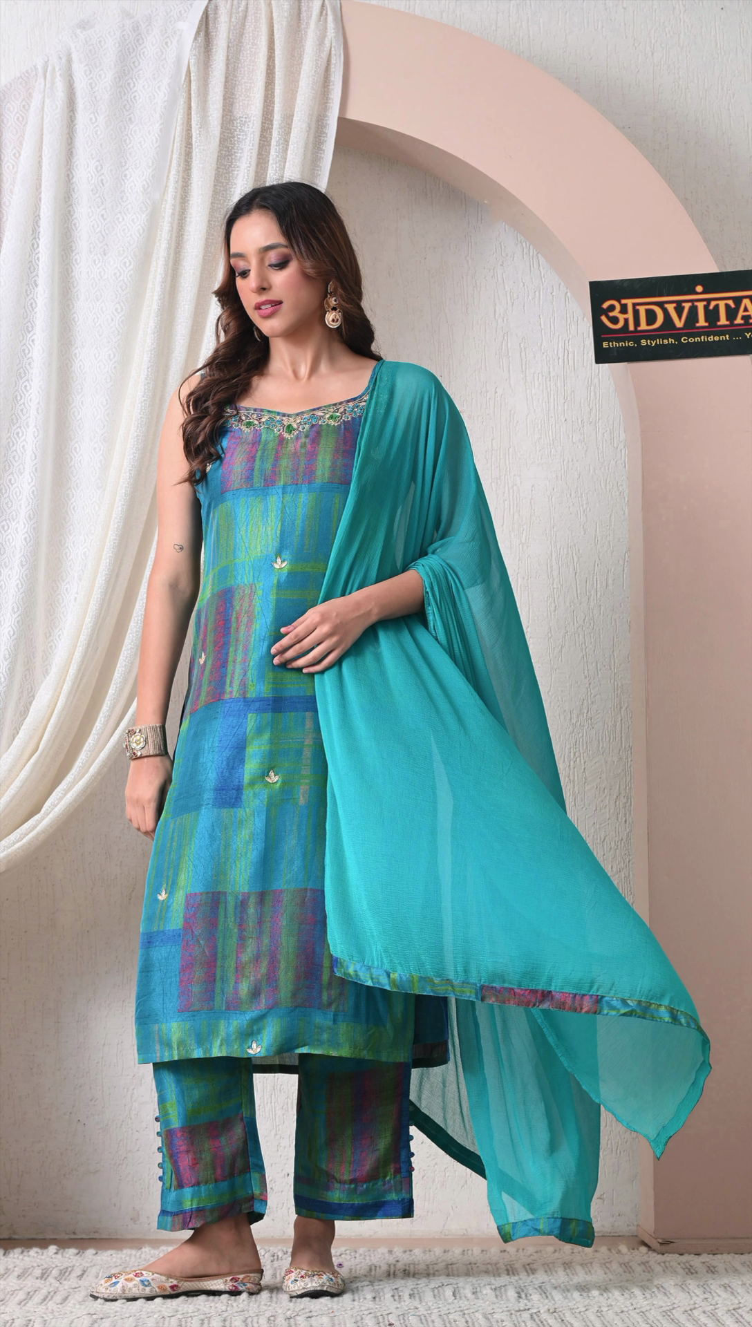 Woman wearing teal blue muslin silk kurti set with dupatta