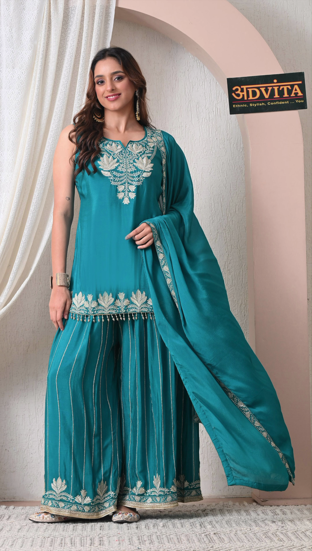 Woman wearing teal green chinon embroidered sharara set with dupatta