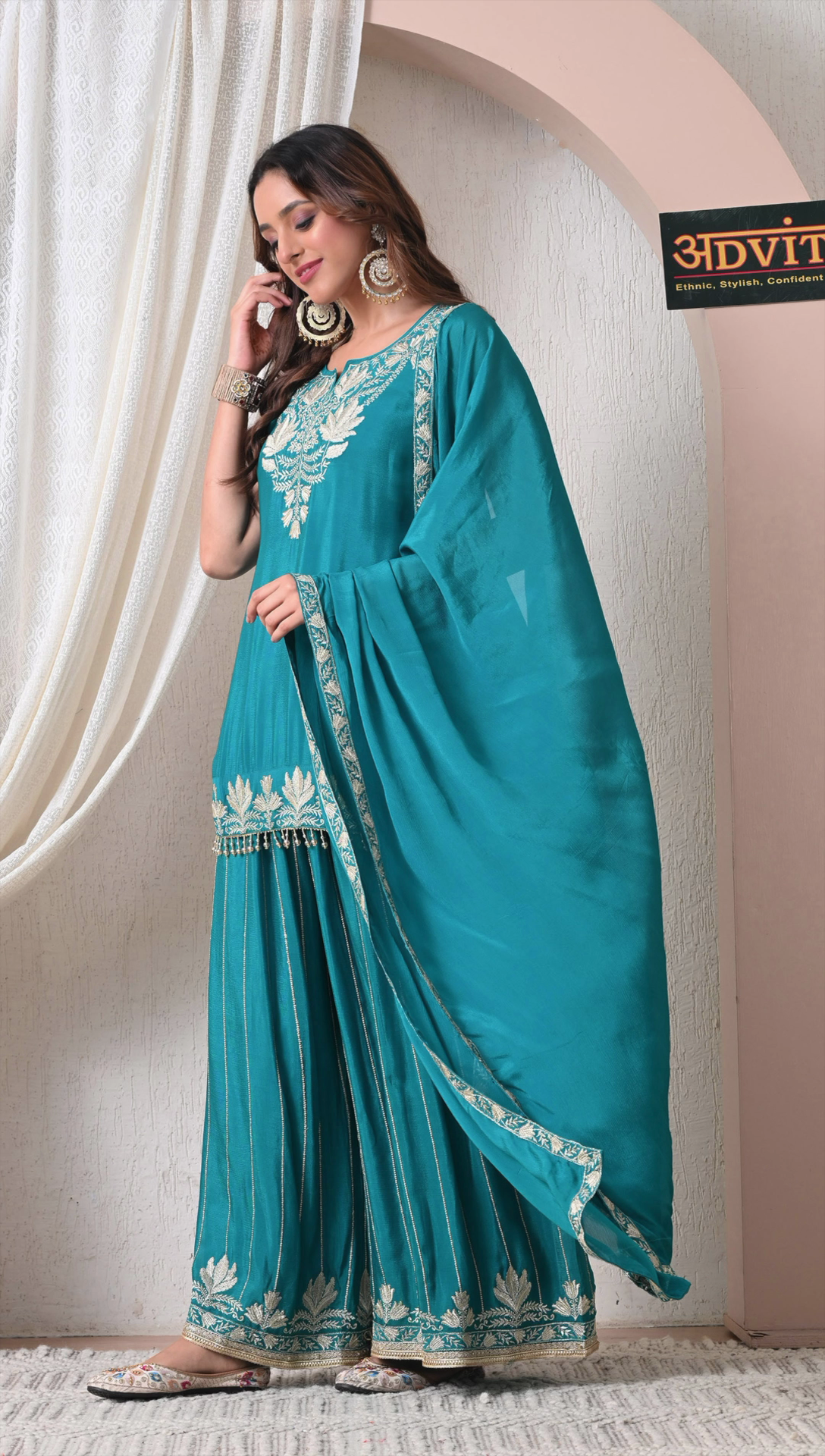 Side view of teal green party wear sharara set for women