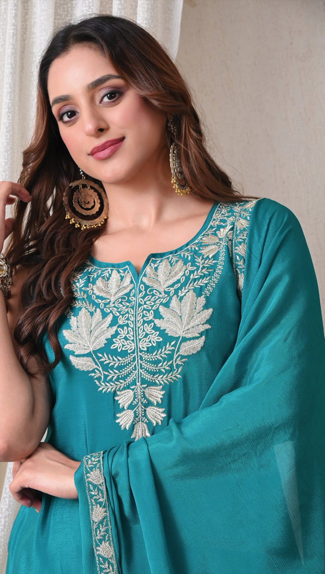 Closeup embroidery detailing on teal green chinon sharara suit